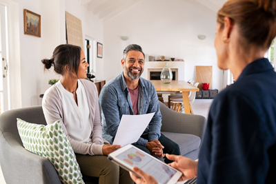 happy couple talking to mortgage advisor