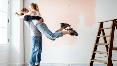 young couple embracing whilst decorating home