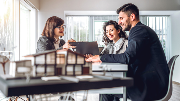 mortgage adviser talking couple through options in office