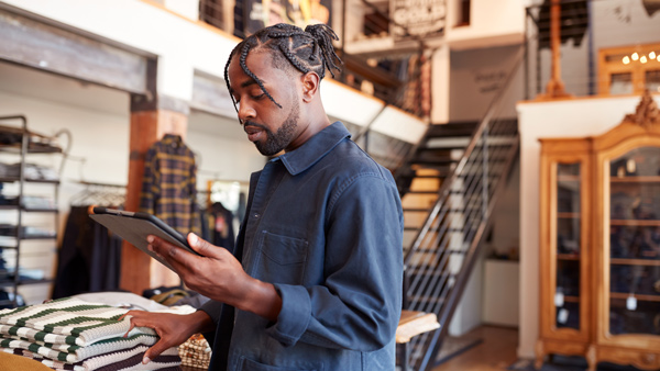 business store owner on ipad in store